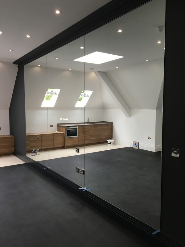 Frameless glass partition in loft conversion by Leytonstone glaziers